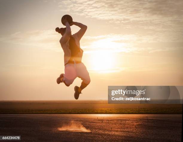 street basketball at sunset - jump shot stock pictures, royalty-free photos & images