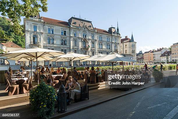 cafe by river ljubljanica, ljubljana, slovenia - ljubljana stock pictures, royalty-free photos & images