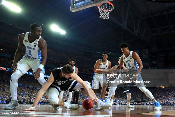 Killian Tillie of the Gonzaga Bulldogs competes for a loose ball against Theo Pinson and Isaiah Hicks of the North Carolina Tar Heels in the second...