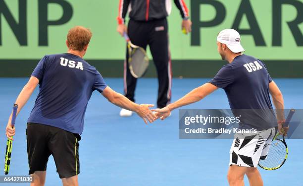 Sam Querrey and Jack Sock of the USA celebrate winning a point during a practice session ahead of the Davis Cup World Group Quarterfinals tie between...