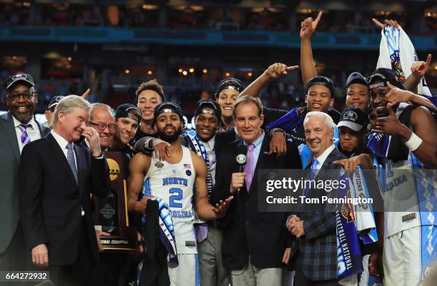 Joel Berry II and head coach Roy Williams of the North Carolina Tar Heels celebrate with their team after defeating the Gonzaga Bulldogs as NCAA...