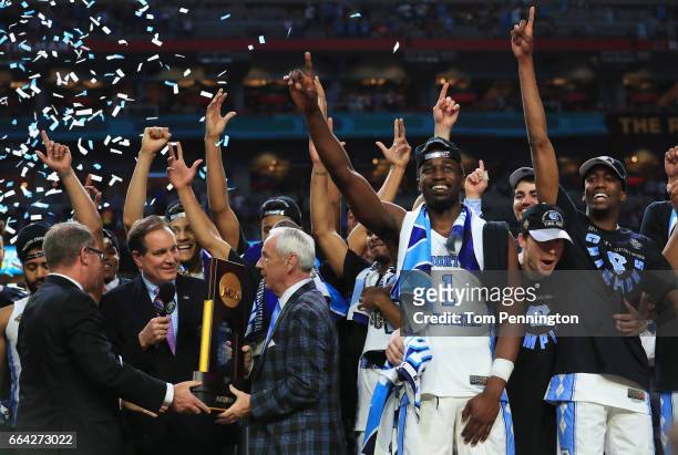 Head coach Roy Williams of the North Carolina Tar Heels receives the Championship trophy after defeating the Gonzaga Bulldogs during the 2017 NCAA...