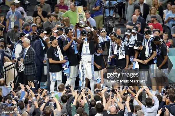 Theo Pinson of the North Carolina Tar Heels hoists the championship trohy with teammates during the 2017 NCAA Photos via Getty Images Men's Final...