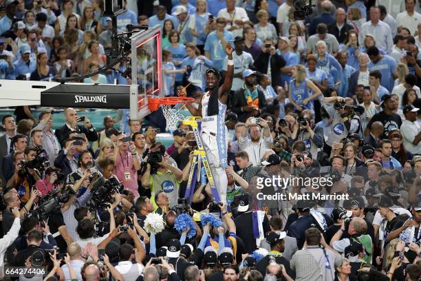 Theo Pinson of the North Carolina Tar Heels cuts a piece of the net during the 2017 NCAA Photos via Getty Images Men's Final Four National...