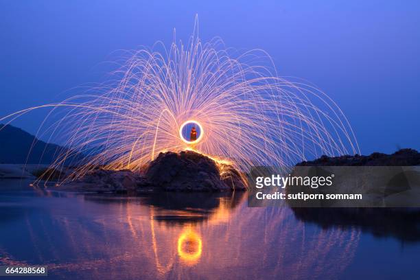 amazing fire show on the stone - fire performer stock pictures, royalty-free photos & images