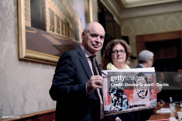 Claudio Regeni an Paola Regeni show the photo of a mural on a wall of Berlin depicting their son Giulio Regeni,during a press conference at the...