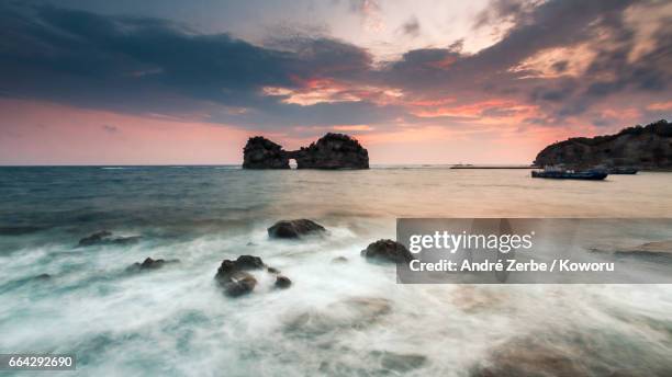 sunset at coast, coastline in front ot engetsu-to in shirahama, japan on a summer day - felsenküste stock pictures, royalty-free photos & images