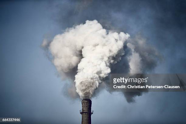 air pollution from chinese factory chimney - schornstein stock-fotos und bilder