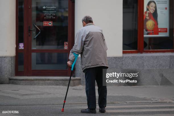An elderly man on crutches is seen in the center of Bydgoszcz, Polan on 3 April, 2017. Poland has seen it's economy grow with a steady increase of...