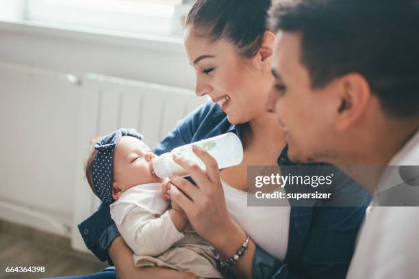 happy family - baby bottle stock pictures, royalty-free photos & images