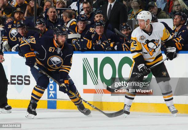 Brady Austin of the Buffalo Sabres skates against Patric Hornqvist of the Pittsburgh Penguins during an NHL game at the KeyBank Center on March 21,...