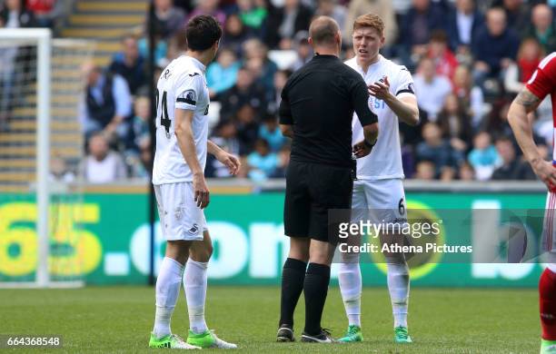 Alfie Mawson of Swansea City talks with referee R Madley during the Premier League match between Swansea City and Middlesbrough at The Liberty...