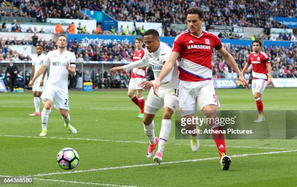 Martin Olsson of Swansea City is challenged by Bernardo Espinosa of Middlesbrough during the Premier League match between Swansea City and...
