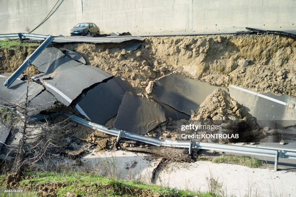 A destroyed road because of the wide landslide unleashed in...