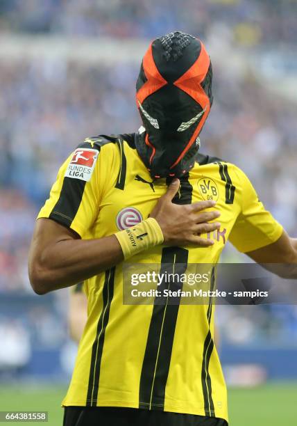 Pierre Emerick Aubameyang celebrates as he scores the goal with a mask during the Bundesliga match between FC Schalke 04 and Borussia Dortmund at...