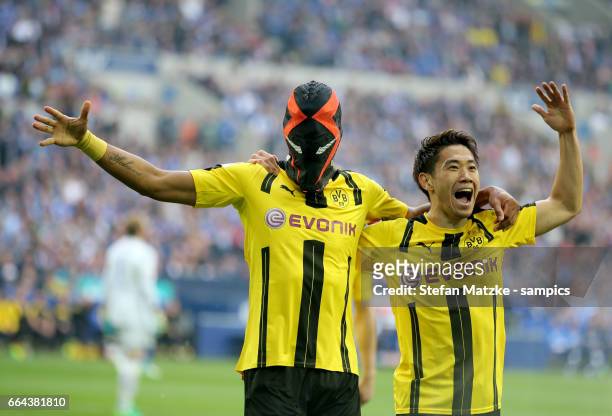 Pierre Emerick Aubameyang celebrates as he scores the goal with a mask with Shinji Kagawa during the Bundesliga match between FC Schalke 04 and...