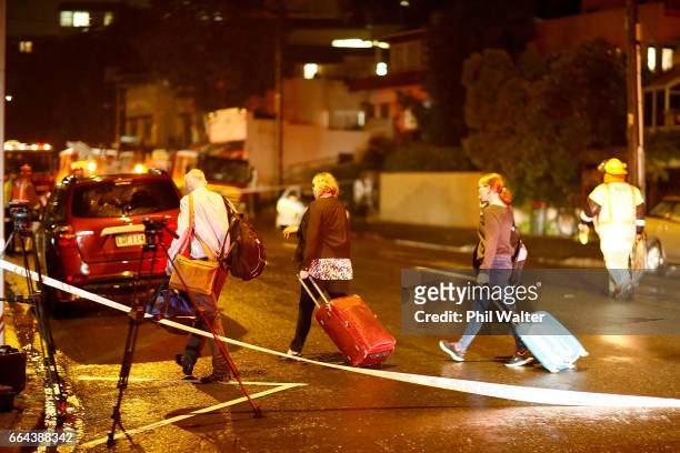 Residents on Kohimarama Road leave with overnight bags as torrential rain caused a nearby hillside to collapse and fall onto apartments. Torrential...
