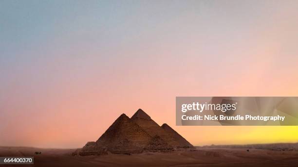 sunset at the pyramids, giza, egypt. - gold pyramid stock pictures, royalty-free photos & images