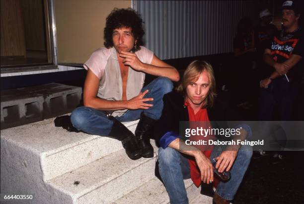 Deborah Feingold/Corbis via Getty Images) CHAMPAIGN Musicians and songwriters Bob Dylan and Tom Petty pose at Farm Aid on September 22, 1985 in...