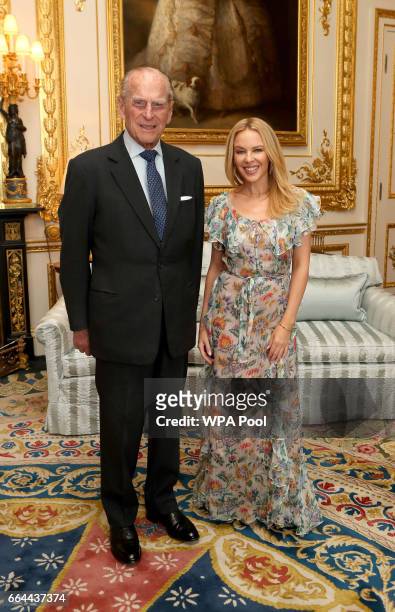 Prince Philip, Duke of Edinburgh, Patron of the Britain-Australia Society, presents Kylie Minogue with the Britain-Australia Society Award for 2016...