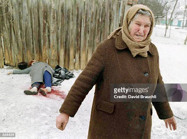 An ethnic Russian woman weeps as she walks past the bodies of a couple killed when a bomb landed between them in the embattled Chechen capital Grozny...