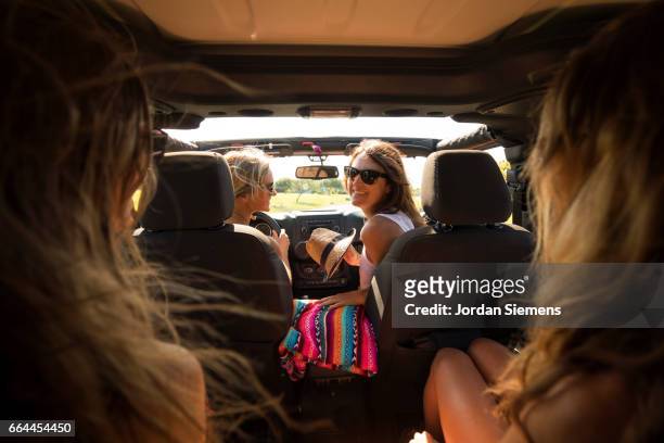 four girls riding in a jeep. - hawaii fun fotografías e imágenes de stock