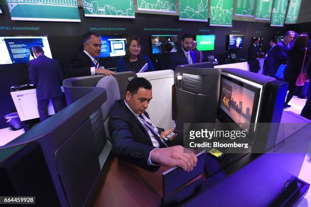 An attendee inspects the first class seating unit and 4K digital screen on display in the Panasonic Avionics Corp. Pavilion at the 2017 Aircraft...
