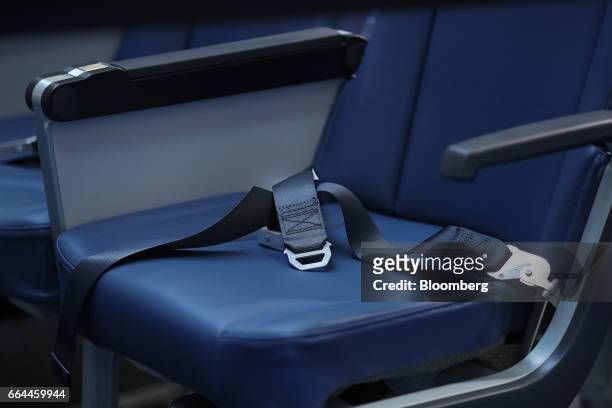 Passenger safety belt sits on an aircraft seat at the 2017 Aircraft Interiors Expo in Hamburg, Germany, on Tuesday, April 4, 2017....