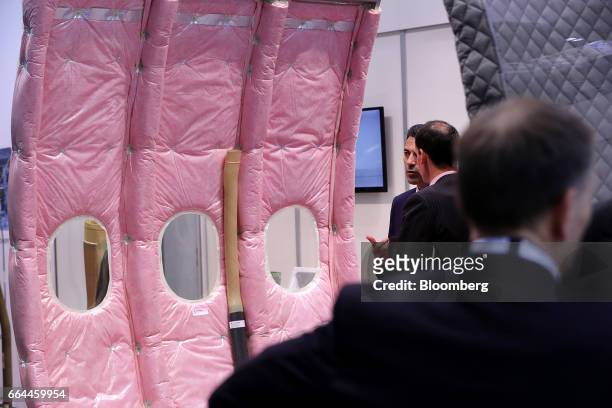 Attendees pass aircraft cabin insulation material manufactured by Hutchinson Composite Industrie at the 2017 Aircraft Interiors Expo in Hamburg,...