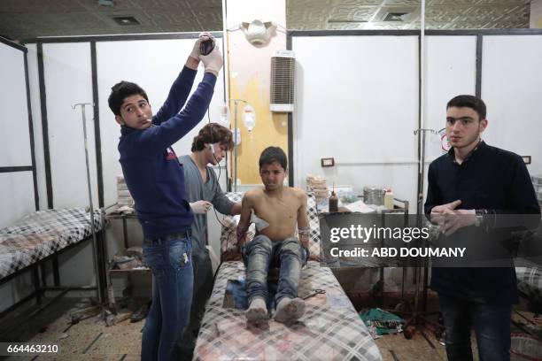 Syrian boy receives treatment at a makeshift clinic following reported air strikes by government forces in the rebel-held town of Douma, on the...