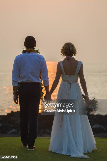 couple pose for photos after hawaii wedding. - interracial wife photos stock-fotos und bilder