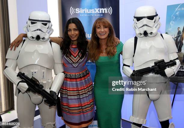 Freida Pinto and Jane Seymour pose with Stormtroopers for Blu-Ray release of Rouge One at SiriusXM Studios on April 4, 2017 in New York City.