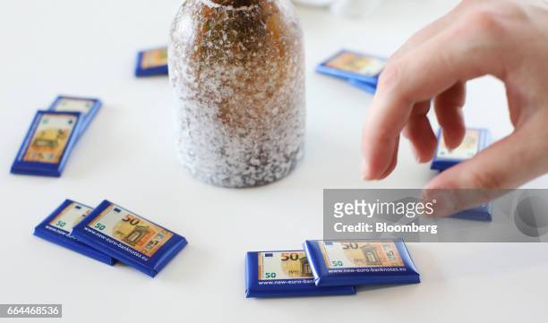 The new 50 euro currency bank note design sits on chocolate wrappers during its unveiling at the European Central Bank headquarters in Frankfurt,...