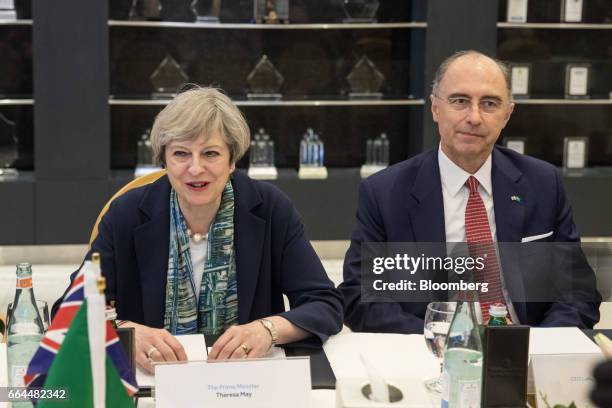 Theresa May, U.K. Prime minister, left, reacts as she attends a meeting with Xavier Rolet, chief executive officer of London Stock Exchange Group...