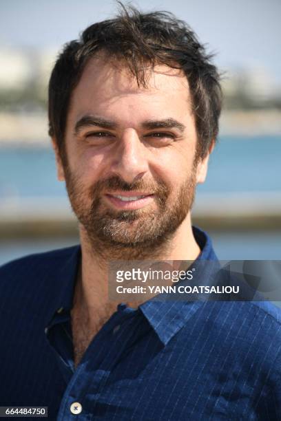 French Actor Gregory Montel, performing in the TV drama "Call My agent" distributed by France TV distribution, poses during the MIPTV event in...
