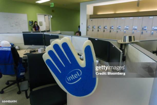 Signage is displayed on a foam hand attached to a cubicle wall at the Intel Corp. Design center stands in Guadalajara, Mexico, on Thursday, March 9,...