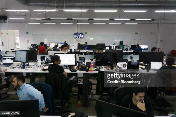 Employees work on computers at the Wizeline Inc. Office in Guadalajara, Mexico, on Friday, March 10, 2017. Guadalajara's Governor Aristoteles...