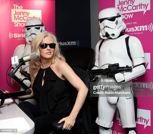 SiriusXM host Jenny McCarthy poses with Stormtroopers for Blu-Ray release of Rouge One during 'The Jenny McCarthy Show' at SiriusXM Studios on April...