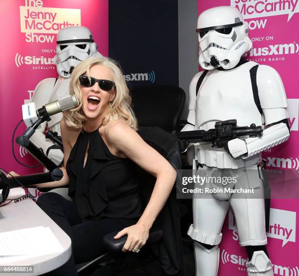 SiriusXM host Jenny McCarthy poses with Stormtroopers for Blu-Ray release of Rouge One during 'The Jenny McCarthy Show' at SiriusXM Studios on April...