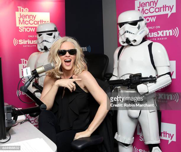 SiriusXM host Jenny McCarthy poses with Stormtroopers for Blu-Ray release of Rouge One during 'The Jenny McCarthy Show' at SiriusXM Studios on April...