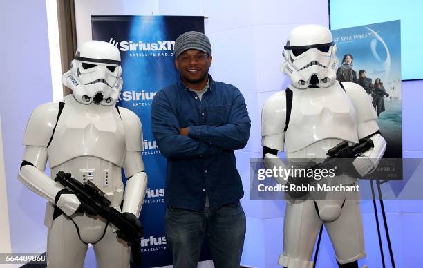 SiriusXM host Sway Calloway poses with Stormtroopers for Blu-Ray release of Rouge One at SiriusXM Studios on April 4, 2017 in New York City.