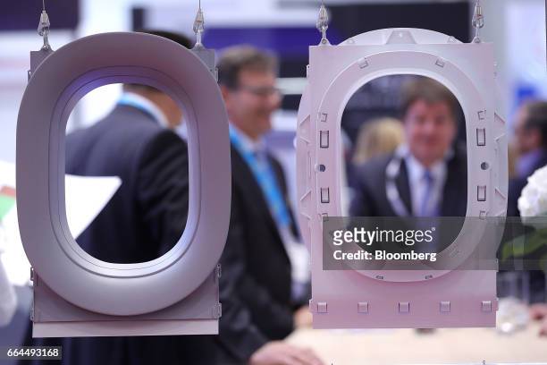 Aircraft window assemblies manufactured by E.I.S. Aircraft GmbH hang on display at the Aircraft Interiors Expo in Hamburg, Germany, on Tuesday, April...