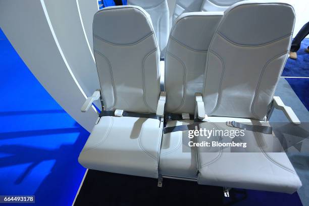 Side-slip passenger seats sit on display in the Molon Labe Designs pavilion at the Aircraft Interiors Expo in Hamburg, Germany, on Tuesday, April 4,...