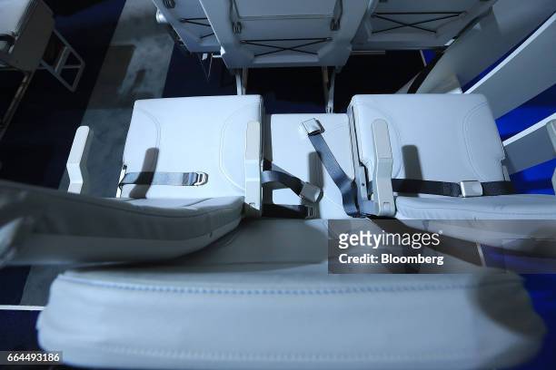 Side-slip passenger seats sit on display in the Molon Labe Designs pavilion at the Aircraft Interiors Expo in Hamburg, Germany, on Tuesday, April 4,...