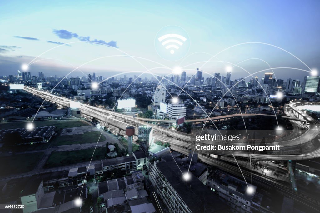 City scape and network connection concept, illuminated by light of cities, surrounded by a luminous network, city network technology