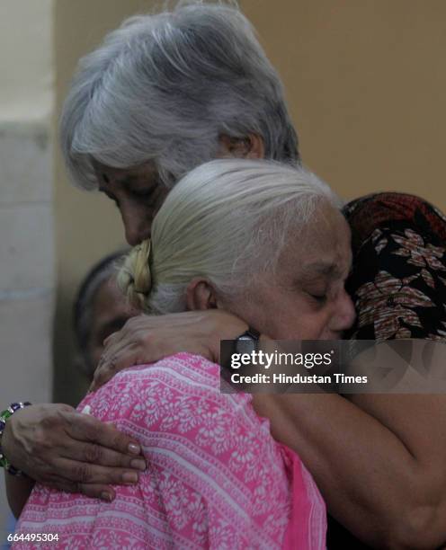 Dilip Sardesai's wife Nandini consoles a relative at the former India cricketer's cremation at the Chandanwadi electrical crematorium in Mumbai.