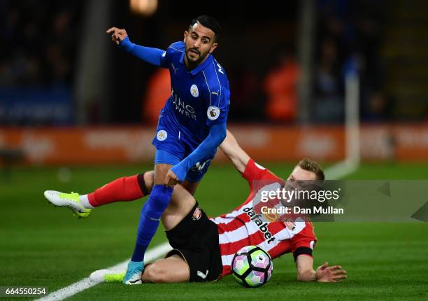 Riyad Mahrez of Leicester City is fouled by Sebastian Larsson of Sunderland during the Premier League match between Leicester City and Sunderland at...