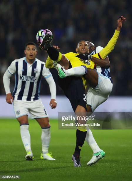 Etienne Capoue of Watford and Allan Nyom of West Bromwich Albion battle for possession during the Premier League match between Watford and West...