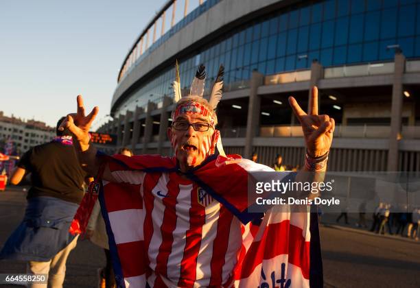 Club Atletico de Madrid fan dressed as an Indian, the nickname of his team, poses for a photograph ahead of the La Liga match between Club Atletico...