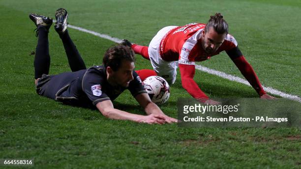 Charlton Athletic's Ricky Holmes and MK Dons Ed Upson battle for the ball during the Sky Bet League One match at The Valley, London.